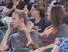 hilarious moment girlfriend pours drink over boyfriend on kiss cam because he kept talking on his phone